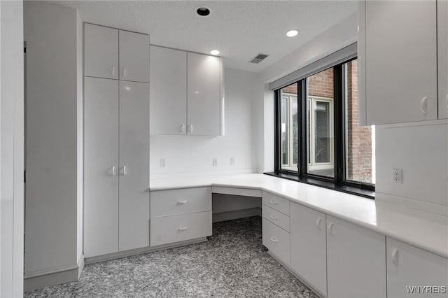 40 Waterfront Cir, Buffalo, NY 14202 - kitchen featuring built in desk, light countertops, recessed lighting, white cabinets, and modern cabinets