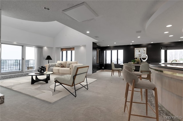 40 Waterfront Cir, Buffalo, NY 14202 - living area with light colored carpet, vaulted ceiling, plenty of natural light, and recessed lighting