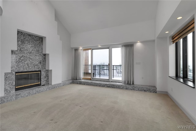 40 Waterfront Cir, Buffalo, NY 14202 - unfurnished living room featuring carpet flooring, high vaulted ceiling, a premium fireplace, and recessed lighting