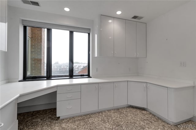 40 Waterfront Cir, Buffalo, NY 14202 - kitchen with recessed lighting, white cabinets, light countertops, built in study area, and modern cabinets