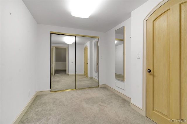 40 Waterfront Cir, Buffalo, NY 14202 - unfurnished bedroom with light carpet, a closet, and arched walkways