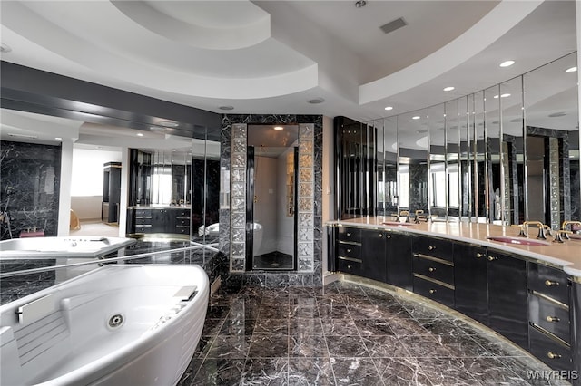 40 Waterfront Cir, Buffalo, NY 14202 - full bathroom featuring double vanity, a jetted tub, a shower stall, marble tiled flooring, and recessed lighting