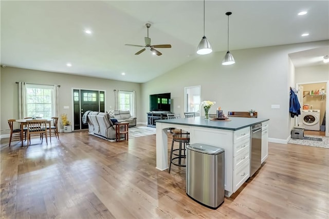 4338 State Route 90, Springport, NY 13160 - kitchen with washer / dryer, white cabinets, healthy amount of natural light, a ceiling fan, and lofted ceiling