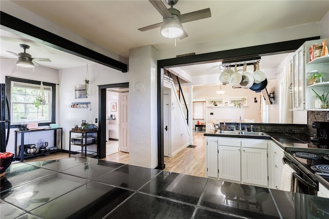 3839 Thompson Ave, Castile, NY 14549 - kitchen with a ceiling fan, dark countertops, white cabinets, and a peninsula