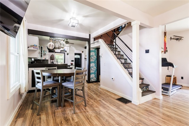 3839 Thompson Ave, Castile, NY 14549 - dining room with stairway, wood finished floors, and a ceiling fan