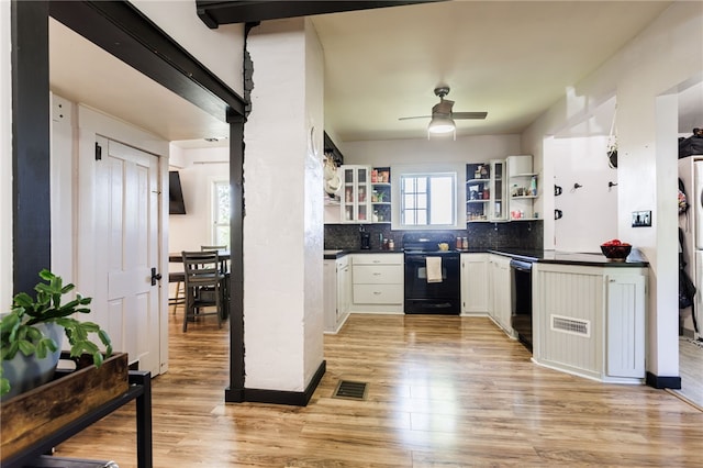 3839 Thompson Ave, Castile, NY 14549 - kitchen featuring black appliances, open shelves, dark countertops, light wood finished floors, and decorative backsplash