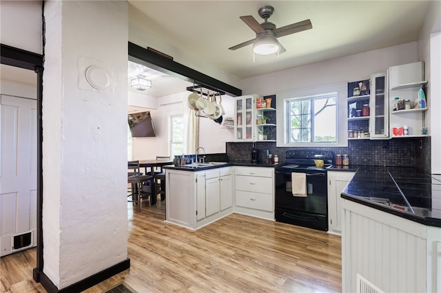 3839 Thompson Ave, Castile, NY 14549 - kitchen with black / electric stove, open shelves, dark countertops, and plenty of natural light