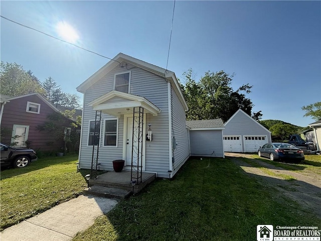 421 E Connell St, Olean-City, NY 14760 - view of front of house with a garage, a front yard, and an outdoor structure