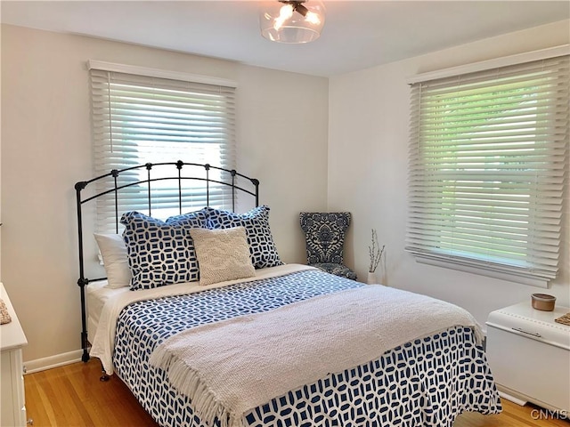 17 Benton Cir, New Hartford, NY 13501 - bedroom with multiple windows and wood finished floors