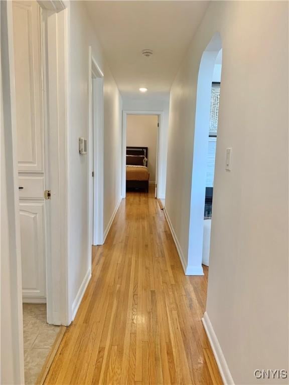 17 Benton Cir, New Hartford, NY 13501 - corridor featuring arched walkways and light wood-style flooring