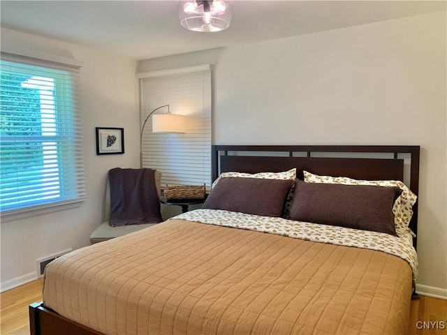 17 Benton Cir, New Hartford, NY 13501 - bedroom featuring multiple windows and wood finished floors