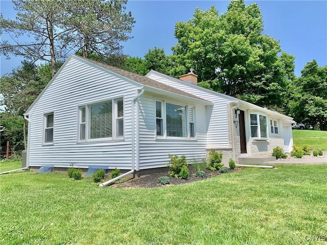 17 Benton Cir, New Hartford, NY 13501 - view of front of home with a chimney and a front lawn