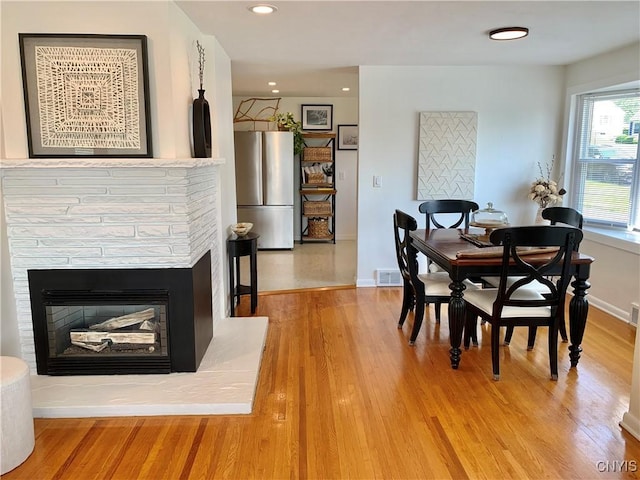 17 Benton Cir, New Hartford, NY 13501 - dining space featuring light wood-style floors, recessed lighting, and a glass covered fireplace