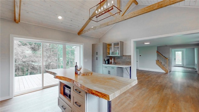 3228 County Road 28, Reading, NY 14891 - kitchen featuring built in microwave, wood finished floors, light countertops, glass insert cabinets, and plenty of natural light
