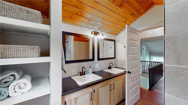 3228 County Road 28, Reading, NY 14891 - bathroom featuring vaulted ceiling, wooden ceiling, double vanity, wood finished floors, and tasteful backsplash