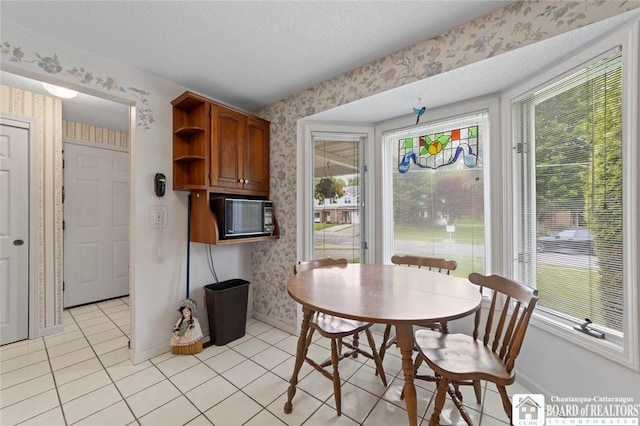 12 Ahrens Pl, Pomfret, NY 14063 - dining space featuring wallpapered walls, light tile patterned floors, and a textured ceiling
