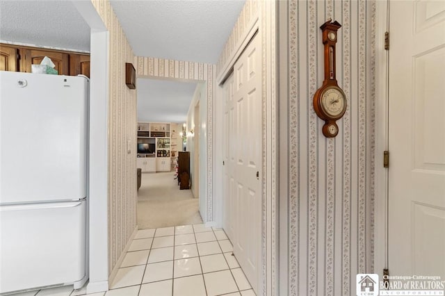 12 Ahrens Pl, Pomfret, NY 14063 - hallway featuring wallpapered walls, light tile patterned floors, light carpet, and a textured ceiling