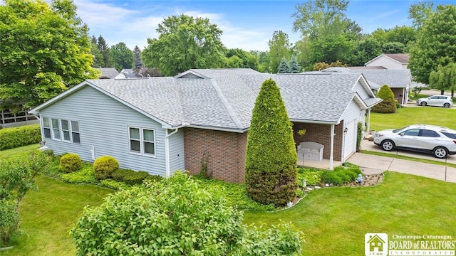 12 Ahrens Pl, Pomfret, NY 14063 - view of property exterior with brick siding, roof with shingles, a yard, driveway, and an attached garage