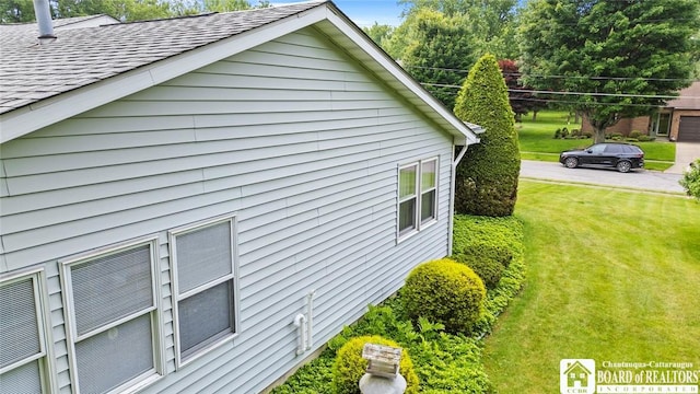 12 Ahrens Pl, Pomfret, NY 14063 - view of side of home featuring a lawn and roof with shingles