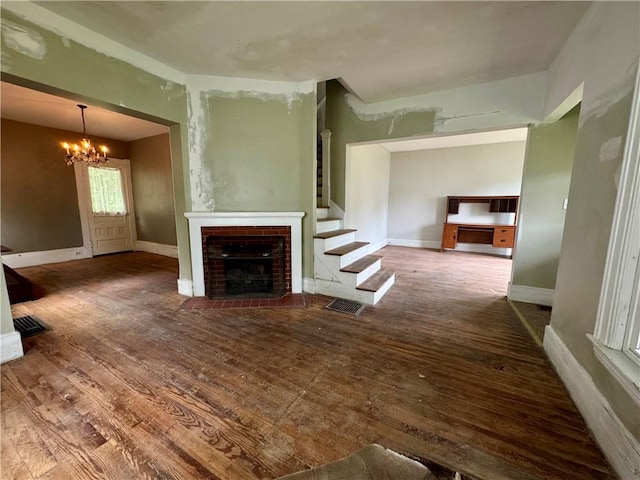 14 Sherman St, Bradford-City, PA 16701 - unfurnished living room with a chandelier, wood-type flooring, a fireplace, and stairway
