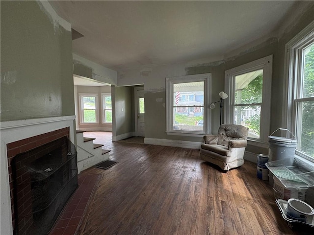 14 Sherman St, Bradford-City, PA 16701 - sitting room featuring dark wood finished floors, a brick fireplace, and plenty of natural light