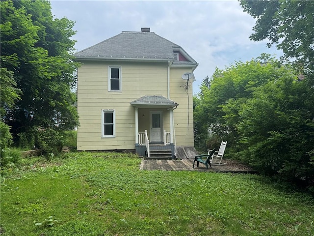 14 Sherman St, Bradford-City, PA 16701 - back of property with a lawn, a patio area, and roof with shingles
