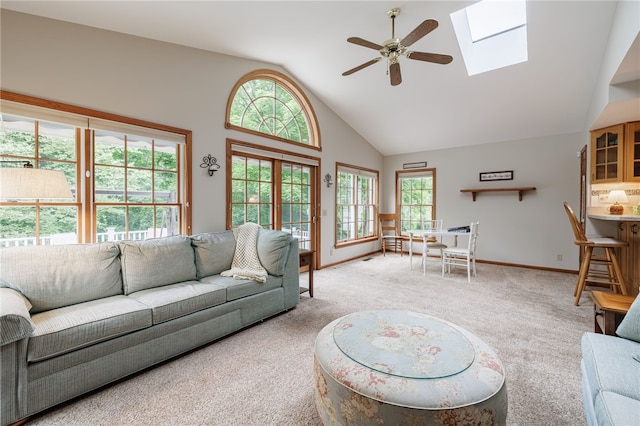 208 Blackwell Ln, Henrietta, NY 14467 - living area featuring ceiling fan, a skylight, light carpet, and high vaulted ceiling
