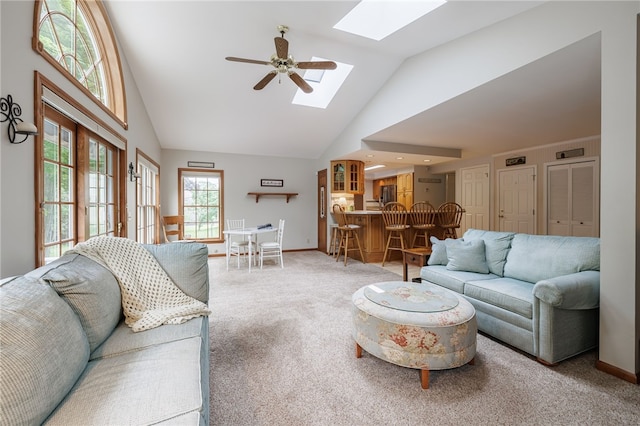208 Blackwell Ln, Henrietta, NY 14467 - living area featuring a skylight, high vaulted ceiling, carpet, and a ceiling fan