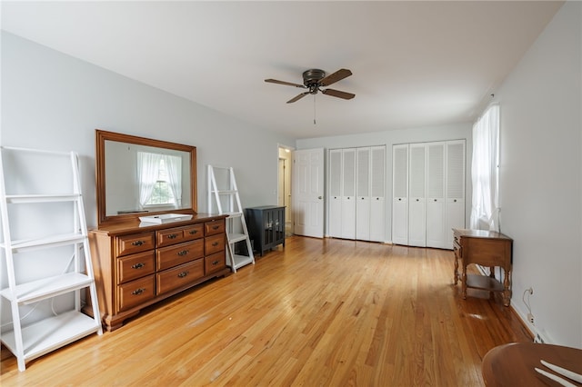 208 Blackwell Ln, Henrietta, NY 14467 - bedroom featuring multiple closets, light wood-type flooring, and a ceiling fan