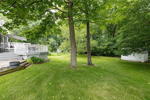 208 Blackwell Ln, Henrietta, NY 14467 - view of green lawn with a deck and an outbuilding