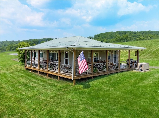 377 Bingham Center Rd, Bingham, PA 16923 - rear view of property with a yard, covered porch, a metal roof, and a forest view