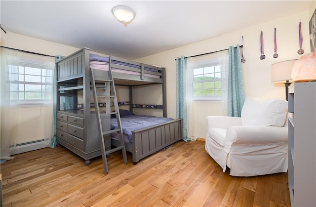 377 Bingham Center Rd, Bingham, PA 16923 - bedroom with baseboard heating and light wood-style floors