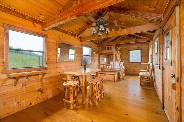 377 Bingham Center Rd, Bingham, PA 16923 - dining space featuring wood walls, wood ceiling, a ceiling fan, light wood-style floors, and healthy amount of natural light