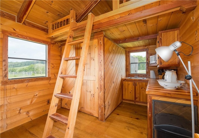 377 Bingham Center Rd, Bingham, PA 16923 - kitchen with wooden walls, light wood-style flooring, and a wooden ceiling with exposed beams