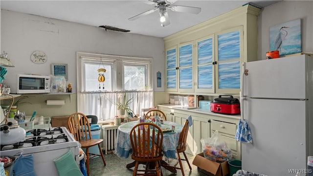 2009 Seneca St, Buffalo, NY 14210 - kitchen with white appliances, ceiling fan, and light countertops
