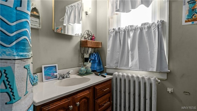 2009 Seneca St, Buffalo, NY 14210 - bathroom featuring radiator heating unit, vanity, and plenty of natural light
