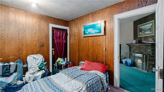 2009 Seneca St, Buffalo, NY 14210 - bedroom featuring a fireplace, carpet, and wood walls