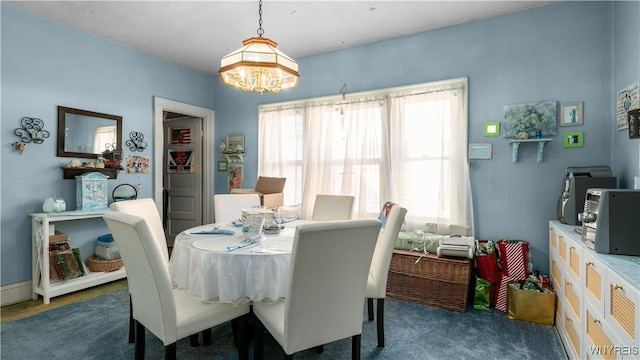 2009 Seneca St, Buffalo, NY 14210 - carpeted dining space with a chandelier