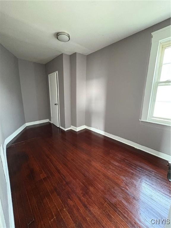 918 Shaw St, Utica, NY 13502 - empty room with dark wood-style flooring and baseboards