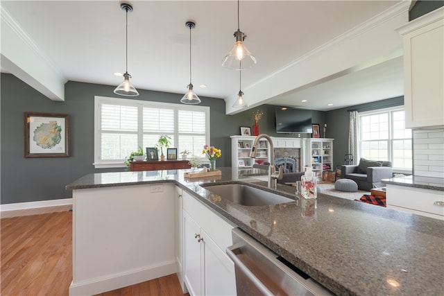 4582 Belwood Dr, Geneseo, NY 14454 - kitchen featuring a fireplace, light wood finished floors, dark stone counters, white cabinetry, and ornamental molding