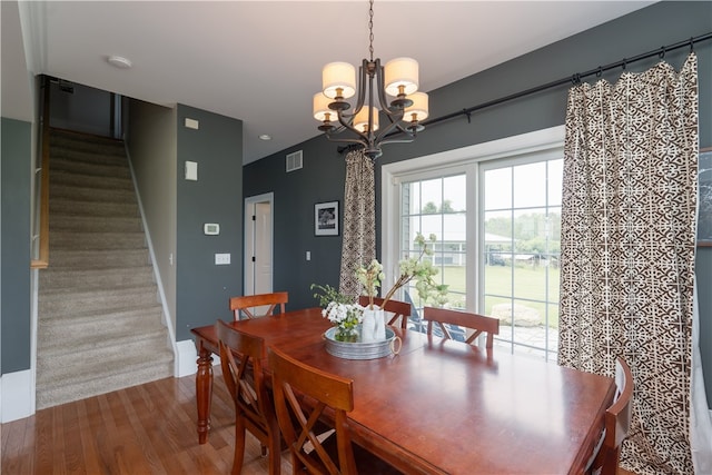 4582 Belwood Dr, Geneseo, NY 14454 - dining room featuring a chandelier, wood finished floors, and stairway