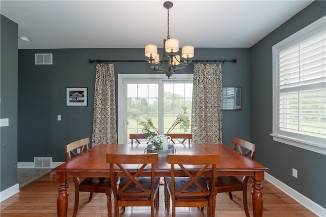 4582 Belwood Dr, Geneseo, NY 14454 - dining space with a chandelier and light wood-style floors