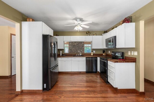 98 Krystyna Ln Unit 6, Cato, NY 13080 - kitchen with black appliances, dark countertops, white cabinetry, and a ceiling fan