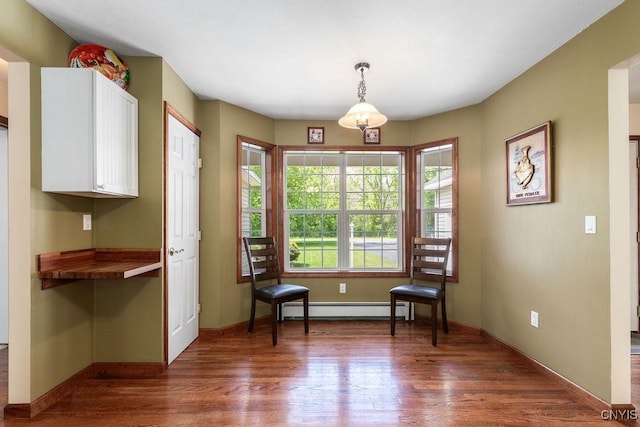 98 Krystyna Ln Unit 6, Cato, NY 13080 - sitting room featuring baseboard heating and dark wood finished floors