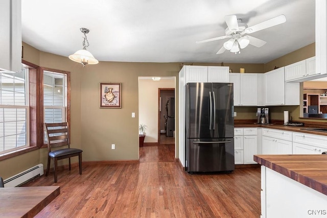 98 Krystyna Ln Unit 6, Cato, NY 13080 - kitchen featuring freestanding refrigerator, a baseboard heating unit, white cabinets, ceiling fan, and dark wood-style flooring
