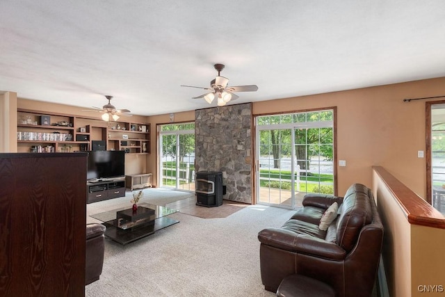 98 Krystyna Ln Unit 6, Cato, NY 13080 - living area with ceiling fan, a wood stove, and carpet floors