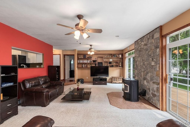 98 Krystyna Ln Unit 6, Cato, NY 13080 - carpeted living area featuring a wood stove and a ceiling fan