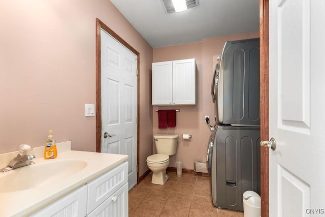 98 Krystyna Ln Unit 6, Cato, NY 13080 - bathroom with estacked washer and dryer, vanity, and tile patterned floors