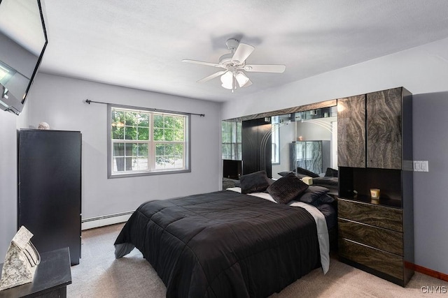 98 Krystyna Ln Unit 6, Cato, NY 13080 - bedroom with light colored carpet, a baseboard radiator, and ceiling fan