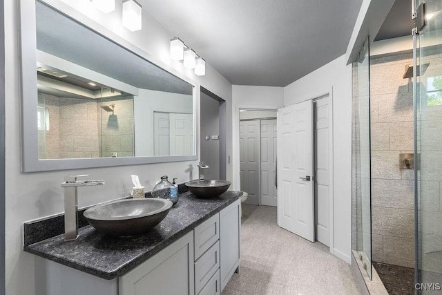 98 Krystyna Ln Unit 6, Cato, NY 13080 - bathroom featuring a stall shower, double vanity, and a closet